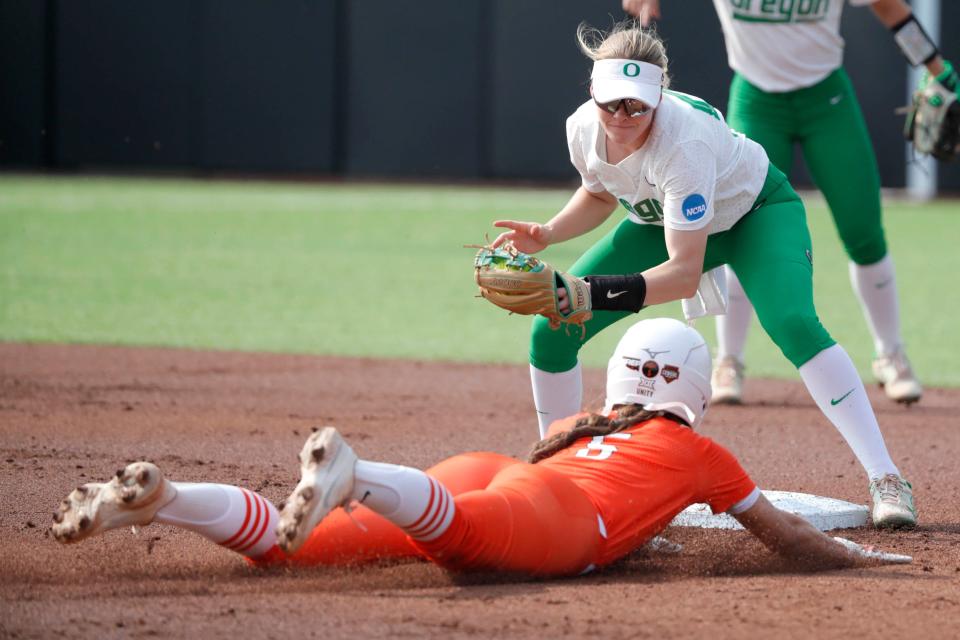 Oregon's Allee Bunker (51) tags out Oklahoma State's Kiley Naomi (5) at second in the first innning of the second game between the Oklahoma State Cowgirls (OSU) and the Oregon Ducks in the Stillwater Super Regional of the NCAA softball tournament in Stillwater, Okla., Friday, May 26, 2023.