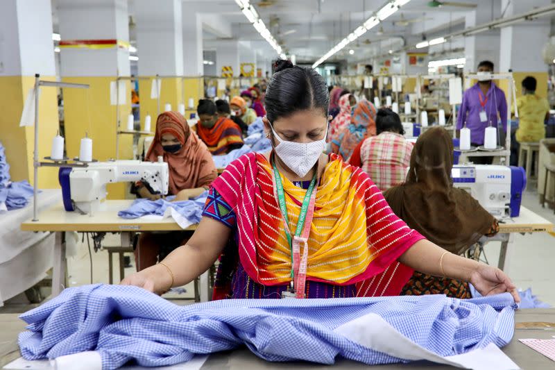 FILE PHOTO: A woman works in a garment factory, as factories reopened after the government has eased the restrictions amid concerns over coronavirus disease (COVID-19) outbreak in Dhaka