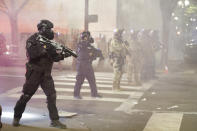 FILE - In this July 28, 2020, file photo, federal officers deploy tear gas and crowd control munitions at demonstrators during a Black Lives Matter protest at the Mark O. Hatfield United States Courthouse in Portland, Ore. Night after night in Portland, tear gas and other crowd control devices enveloped protesters and bystanders in aerosolized compounds that then settled on the ground and wound up washed into storm drains. Test samples from those storm drains have turned up heavy metals and chemicals at much higher levels than samples collected from control sites elsewhere. (AP Photo/Marcio Jose Sanchez, File)