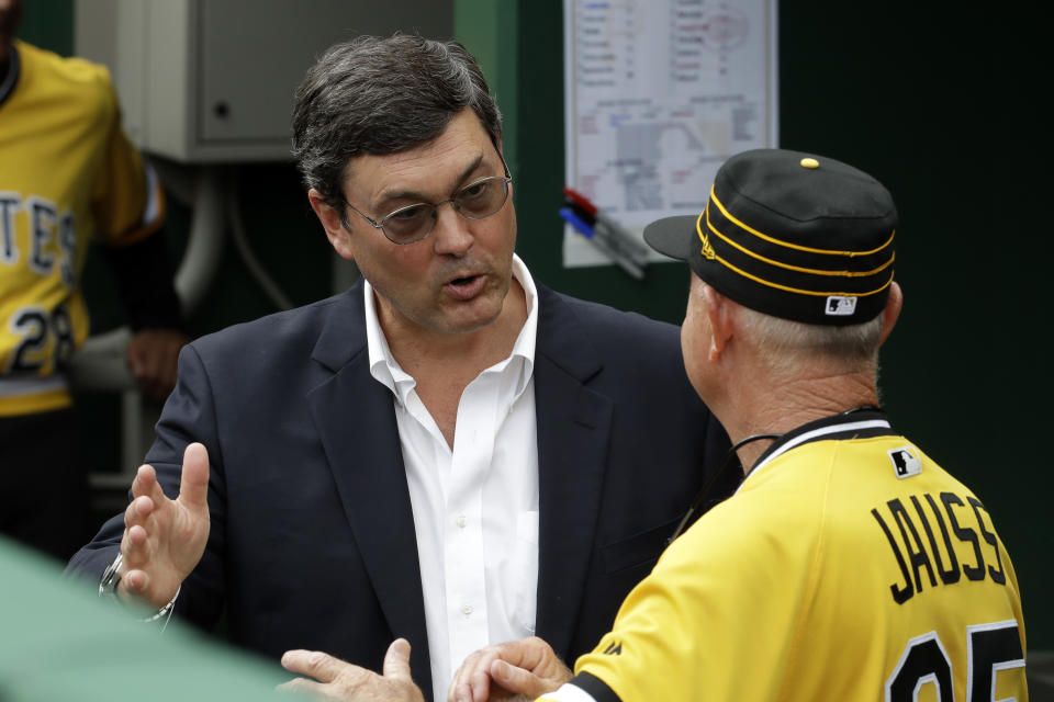 Pittsburgh Pirates chairman Robert Nutting, left, talks with Pirates coach Dave Jauss in the dugout after the firing of manager Clint Hurdle before the final baseball game of the season against the Cincinnati Reds in Pittsburgh, Sunday, Sept. 29, 2019. (AP Photo/Gene J. Puskar)