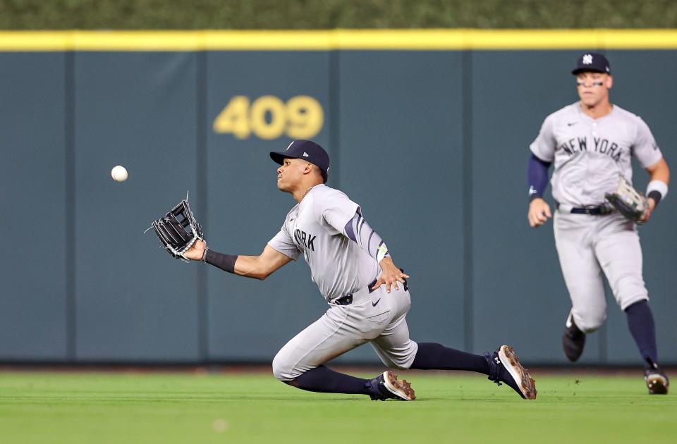Mar 29, 2024; Houston, Texas, USA; New York Yankees right fielder Juan Soto (22) makes a sliding catch of a fly ball during the seventh inning against the Houston Astros at Minute Maid Park. Mandatory Credit: Troy Taormina-USA TODAY Sports