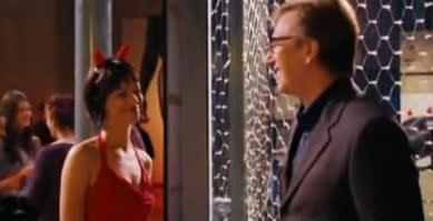 Harry looking at Mia, who's in a red dress, in "Love Actually"