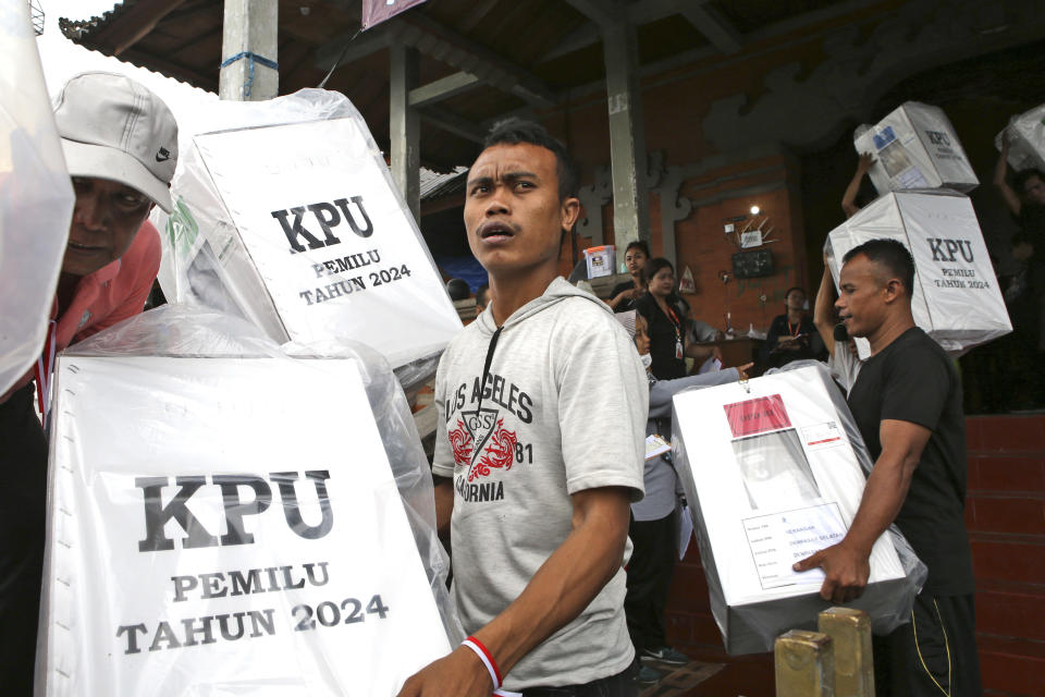 Workers carry ballot boxes for distribution to polling stations ahead of Feb. 14 election in Denpasar, Bali, Indonesia on Monday, Feb. 12, 2024. Indonesia, the world's third-largest democracy, will open its polls on Wednesday to nearly 205 million eligible voters in presidential and legislative elections, the fifth since Southeast Asia's largest economy began democratic reforms in 1998. (AP Photo/Firdia Lisnawati)