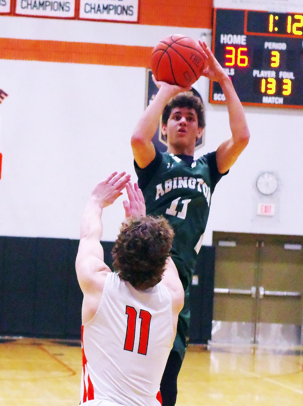 Abington's #11 Kingston Maxwell takes a jump shot in the 2nd half against #11 Oliver Ames' Jake Willard in the 2nd half. The Green Wave built a strong read of OA and was able to build a strong lead after halftime on Thursday, Feb. 14, 2024.