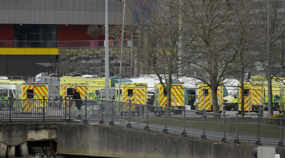 A line of London ambulances outside the ExCel center, which is being turned into a 4000 bed temporary hospital called NHS Nightingale to deal with coronavirus patients in London, Monday, March 30, 2020. The new coronavirus causes mild or moderate symptoms for most people, but for some, especially older adults and people with existing health problems, it can cause more severe illness or death.(AP Photo/Matt Dunham)