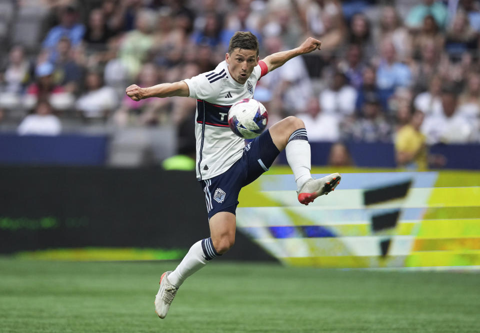 Vancouver Whitecaps' Ryan Gauld jumps to knock down a pass during the first half of the team's MLS soccer match against the Los Angeles Galaxy on Saturday, July 15, 2023, in Vancouver, British Columbia. (Darryl Dyck/The Canadian Press via AP)