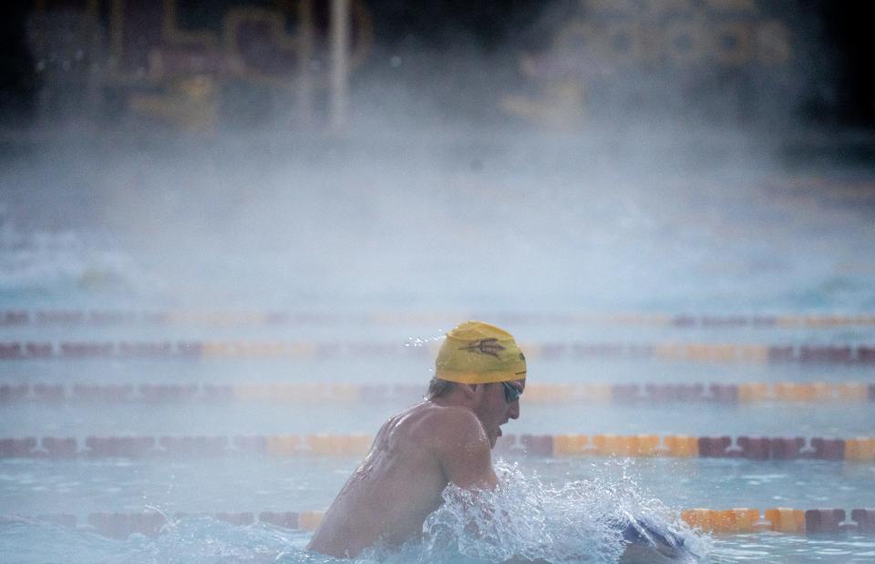 Grant House cuts through the rising steam on Dec. 14, 2022, during practice at ASU's Mona Plummer Aquatic Center in tempe. The temperature during the 6-8 a.m. practice was 37 degrees, and the water temperature was 80 degrees.