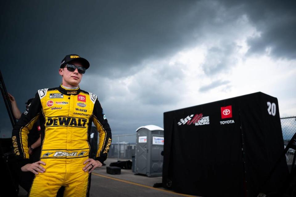 NASCAR Cup Series driver Christopher Bell stands with his crew after exiting his car due to a lightning delay during the Ally 400 at Nashville Superspeedway in Lebanon, Tenn., Sunday, June 30, 2024.