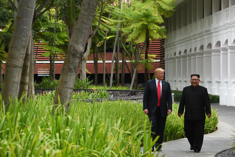 Trump and Kim walk&nbsp;after lunch.