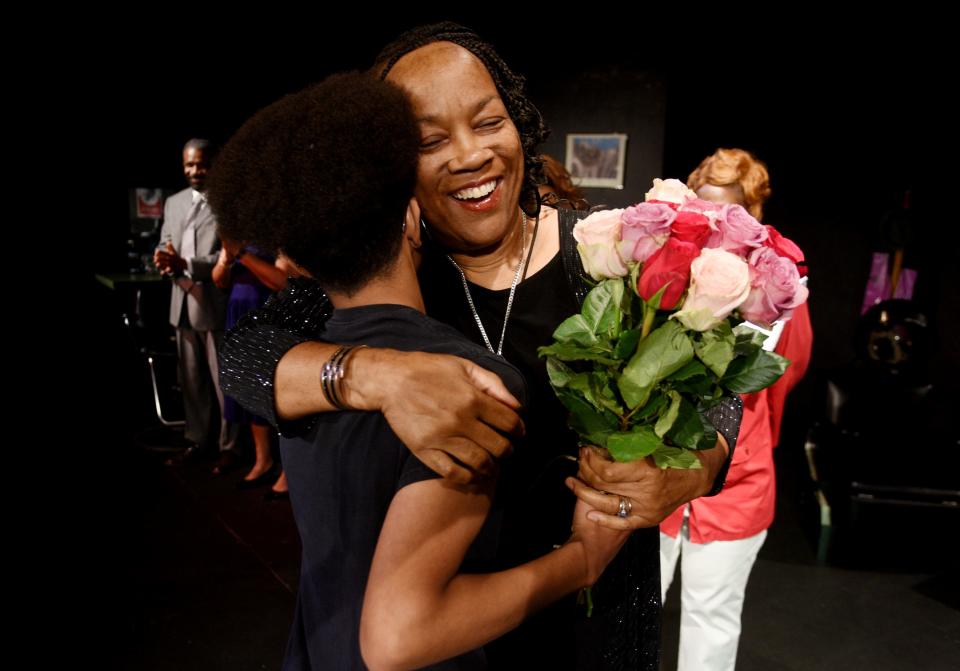 Carolyn Jones gets flowers after a performance of her play, Beauty and the Ballot Box, at East Bank Theatre.