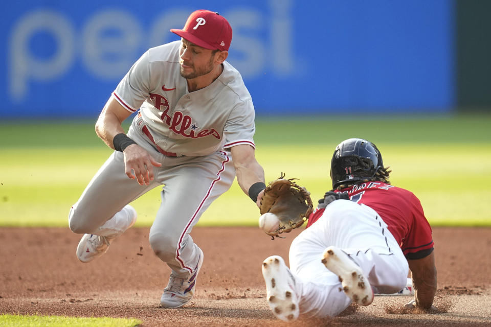 Cleveland Guardians' Jose Ramirez, right, steals second base as Philadelphia Phillies shortstop Trea Turner takes a throw in the first inning of a baseball game Friday, July 21, 2023, in Cleveland. (AP Photo/Sue Ogrocki)