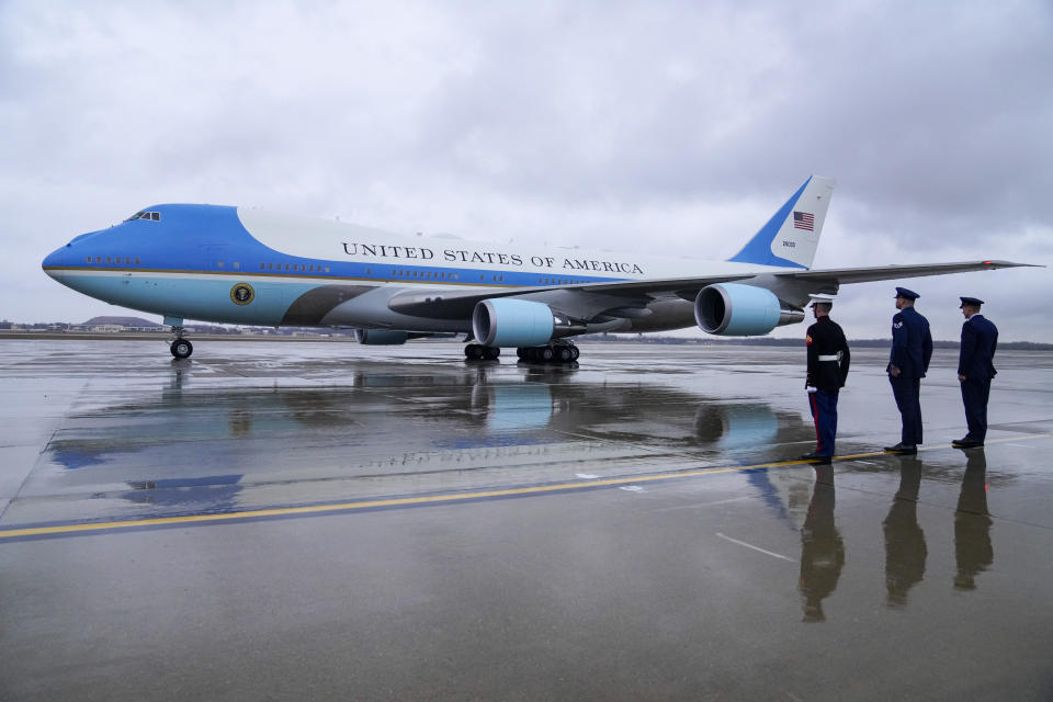 FILE - Military officers look on as Air Force One, with President Joe Biden, prepares for takeoff at Andrews Air Force Base, Md., Tuesday, Jan. 31, 2023, en route to New York. When Joe Biden was running for president three years ago, he flew on a white private jet with his campaign logo painted on the side. Now he has a larger, more recognizable ride as he seeks a second term. Like his predecessors, he'll be crisscrossing the country on Air Force One. (AP Photo/Jess Rapfogel, File)