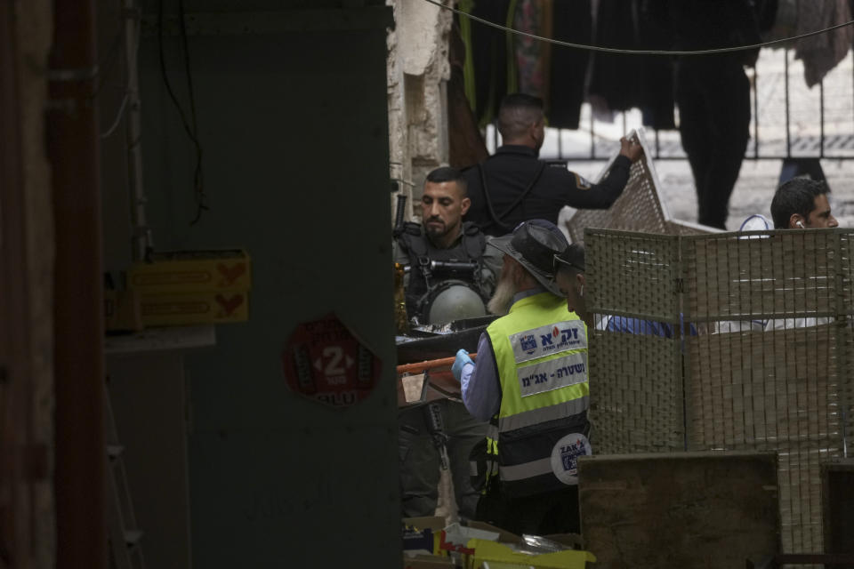 Israeli rescue workers carry the body of a Palestinian attacker from the scene of a stabbing attack in Jerusalem's Old City, Thursday, Nov. 3, 2022. The Palestinian stabbed a police officer lightly wounding him, and officers opened fire killing him, Israeli police said. (AP Photo/Mahmoud Illean)