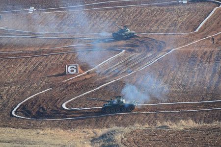 Tanks are seen during the Korean People's Army (KPA) tank crews' competition at an unknown location, in this undated photo released by North Korea's Korean Central News Agency (KCNA) in Pyongyang on March 11, 2016. REUTERS/KCNA