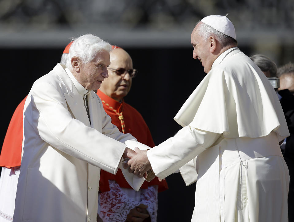 FILE - Pope Francis, right, greets Pope Emeritus Benedict XVI at the end of a meeting with elderly faithful in St. Peter's Square at the Vatican on Sept. 28, 2014. Pope Emeritus Benedict XVI, the German theologian who will be remembered as the first pope in 600 years to resign, has died, the Vatican announced Saturday. He was 95. (AP Photo/Gregorio Borgia, File)