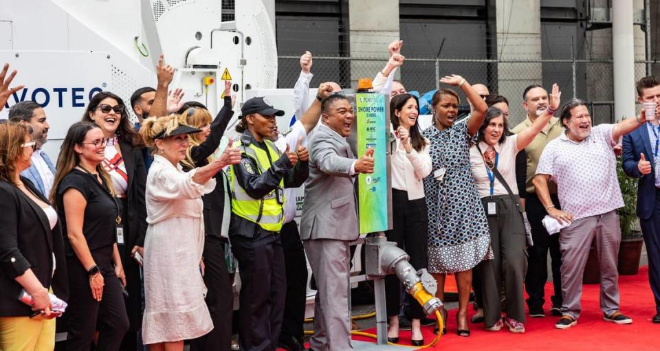 Deputy Port Director Frederick Wong (in center wearing gray suit) cheers with attendees at a ribbon cutting ceremony on Monday, June 17, 2024 in Miami, Fla. The event officially launched shore power at PortMiami, allowing cruise shops to turn off their engines and plug into a land side electrical power while docked, resulting in reduced emissions and noise.