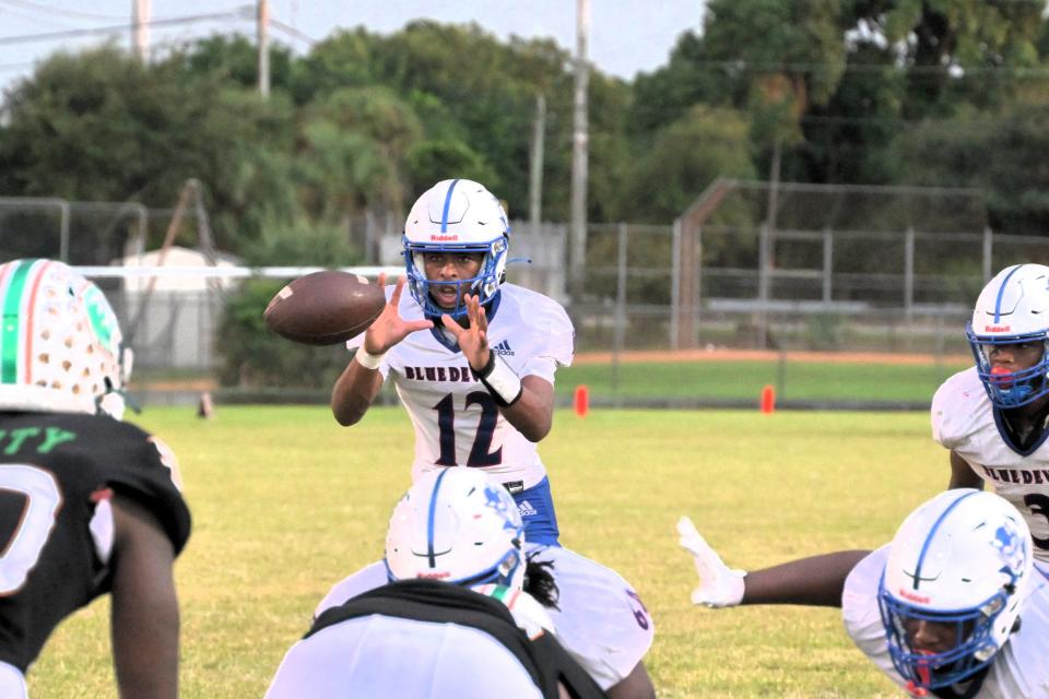 Pahokee quarterback Xavier Mitchell calls for the snap during the first half of the Blue Devils’ regular season game against Atlantic on Oct. 6, 2023.