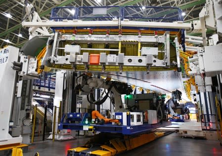 A fixed-bed robot works in a wing assembly station during a media tour of the Boeing 777X at the Boeing production facility in Everett