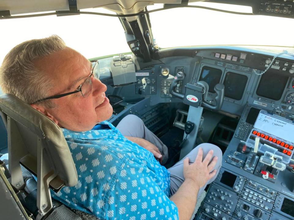 Mike Dodt, director of the aviation maintenance technology program at San Joaquin Valley College’s Fresno Yosemite International Airport campus, sits behind the controls of a CRJ200 regional jet donated to the school by SkyWest Airlines to help train students to be aircrat mechanics.