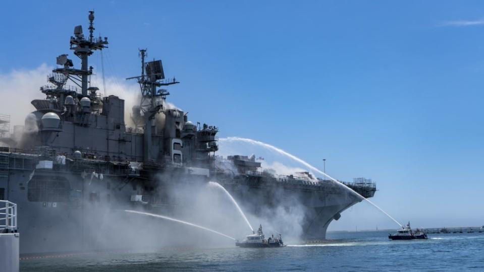 Firefighters battle a fire aboard the US Navy amphibious assault ship USS Bonhomme Richard