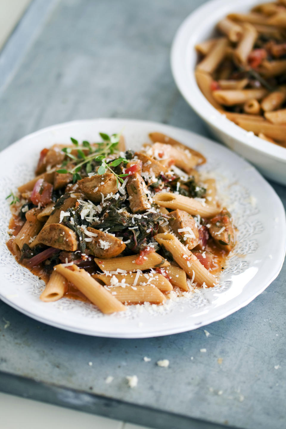 In this image taken on April 15, 2013, whole-wheat penne with spring greens and sausage is shown served on a plate in Concord, N.H. (AP Photo/Matthew Mead)