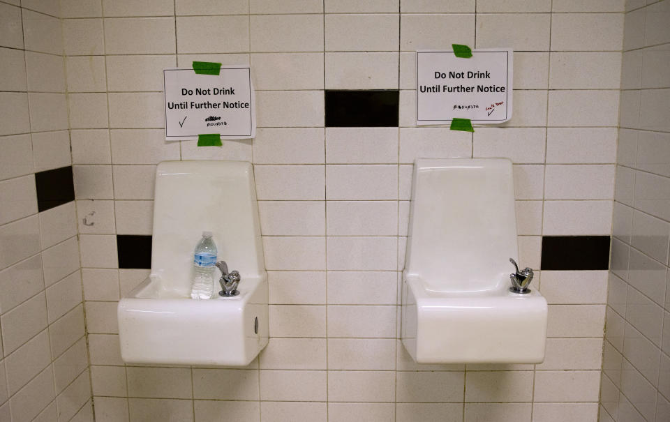 Water fountains with signs warning against drinking from them at a high school in Flint, Michigan, in May 2016. In 2014 the city changed its water source, resulting in lead contamination that persisted for more than a year.&nbsp; (Photo: ASSOCIATED PRESS)