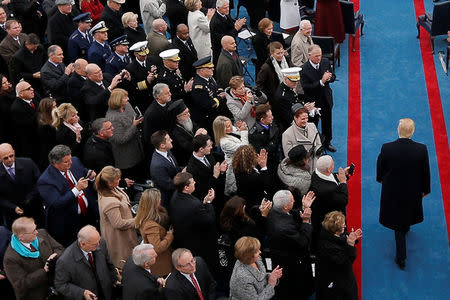 FILE PHOTO: Former National Security Adviser Michael Flynn (Upper L) looks down at a mobile phone as U.S. President-elect Donald Trump arrives for the inauguration ceremonies on the West front of the U.S. Capitol in Washington, U.S., January 20, 2017. REUTERS/Brian Snyder/File photo