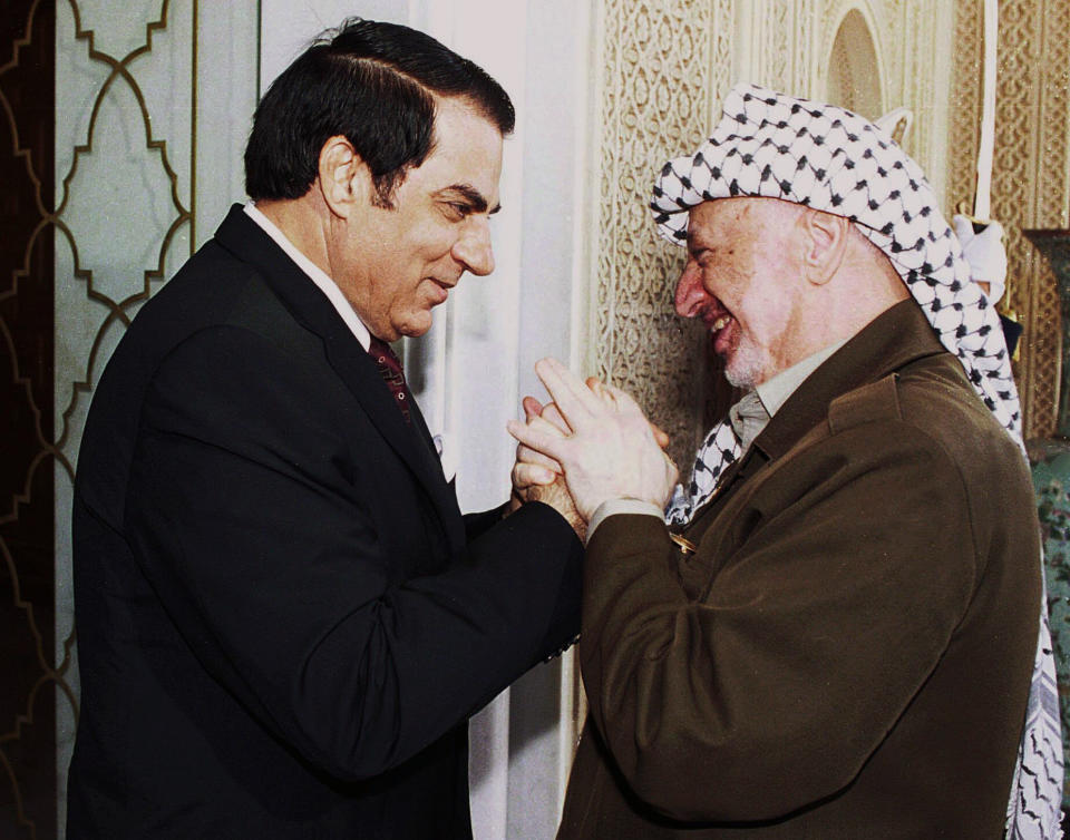 FILE - In this Oct. 1, 2001 file photo, Tunisian President Zine El Abidine Ben Ali, left, welcomes Palestinian leader Yasser Arafat prior to their talks in Tunis. Tunisia's autocratic ruler Zine El Abidine Ben Ali, toppled in 2011, died in exile in Saudi Arabia. (AP Photo/File)