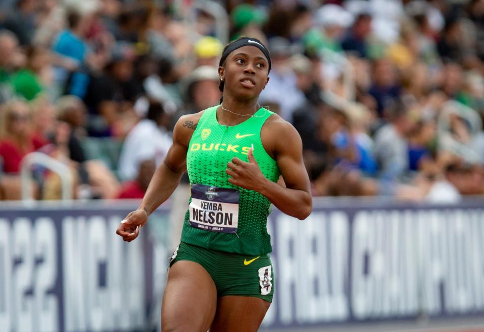 Oregon's Kemba Nelson crosses the finish line to win her heat in the semifinals of the women's 100 meter dash on the second day of the NCAA Outdoor Track & Field Championships Thursday, June 9, 2022 at Hayward Field in Eugene, Ore.
