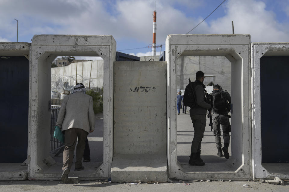 Palestinians cross from the Israeli military Qalandia checkpoint near the West Bank city of Ramallah to Jerusalem, to participate in Friday prayers at the Al-Aqsa Mosque compound during the Muslim holy month of Ramadan on Friday, March 15, 2024. (AP Photo/Nasser Nasser)