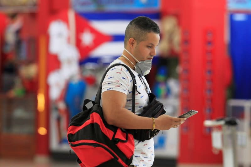 A man with his face mask pulled down is seen at Jose Marti International Airport, in Havana