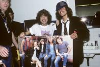<p>Angus Young from AC/DC poses backstage at the Nassau Coliseum with a poster of the band. The guitarist was <a href="https://www.npr.org/sections/thetwo-way/2017/11/18/565082739/ac-dcs-malcolm-young-dies-age-64" rel="nofollow noopener" target="_blank" data-ylk="slk:one of the group's cofounding members;elm:context_link;itc:0;sec:content-canvas" class="link ">one of the group's cofounding members</a>—he and his brother, Malcom, started the band in their hometown of Sydney, Australia. </p>