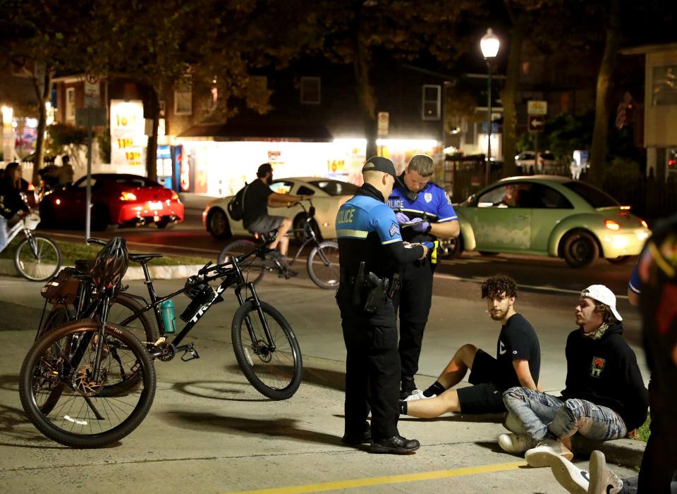 Police write tickets at the unofficial H2Oi popup Friday, Sept. 24, 2021, in Ocean City, Maryland. Law enforcement from around the area were in full force, enforcing the special event zone thoughout Ocean City and Worcester County.