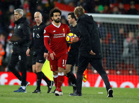 Soccer Football - Premier League - Liverpool vs Watford - Anfield, Liverpool, Britain - March 17, 2018 Liverpool's Mohamed Salah celebrates with the match ball after the match REUTERS/Phil Noble