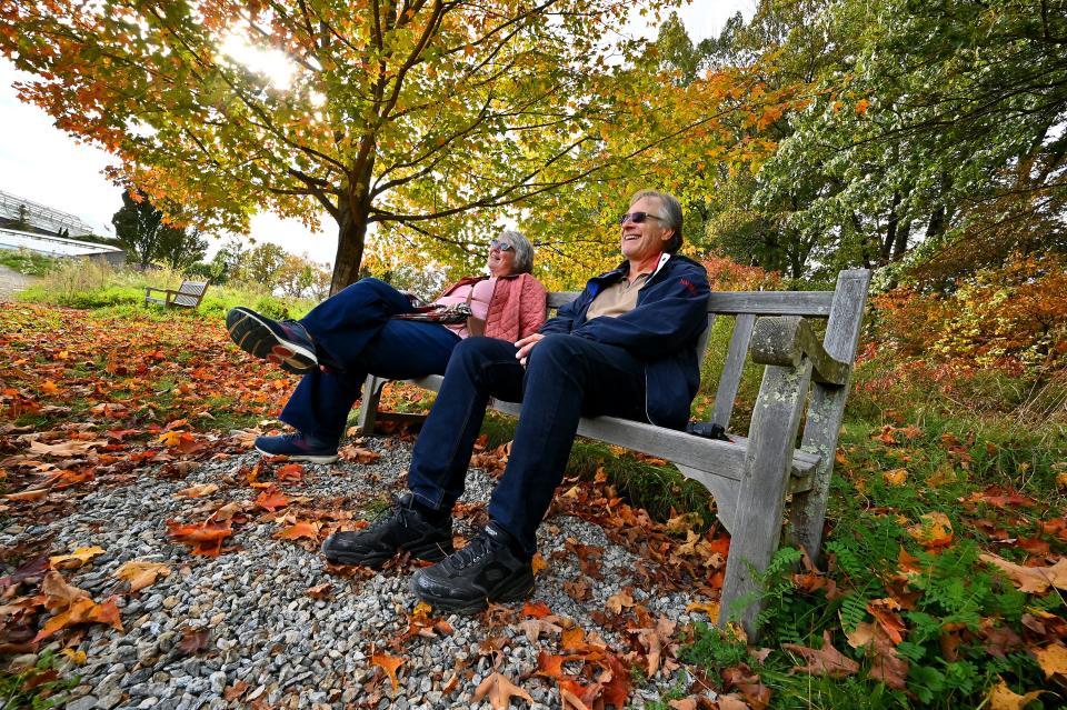 Denise Dayton of Gardner and her brother, Ken Dayton of Los Angeles, enjoy a bench under a sugar maple at New England Botanic Garden at Tower Hill in Boylston.