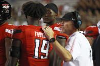 Texas Tech coach Matt Wells, right, talks to Texas Tech's Loic Fouonji (19) during the second half of an NCAA college football game against Florida International, Saturday, Sept. 18, 2021, in Lubbock, Texas. (AP Photo/Brad Tollefson)