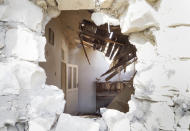 An apartment through a shell-pierced wall after shelling by Azerbaijan's artillery during a military conflict in the town of Martuni, the separatist region of Nagorno-Karabakh, Friday, Oct. 23, 2020. Heavy fighting over Nagorno-Karabakh is continuing with Armenia and Azerbaijan trading blame for new attacks. Two Russia-brokered cease-fires collapsed instantly after taking effect, and the warring parties have continued to exchange blows with heavy artillery, rockets and drones. (AP Photo)