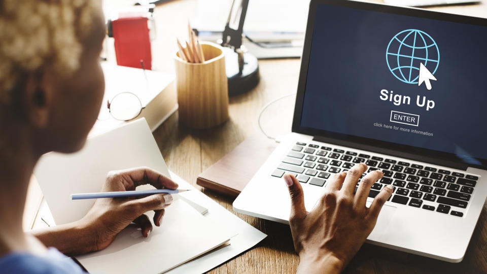 woman signing up for something on laptop