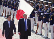 FILE - In this Nov. 6, 2017, file photo, U.S. President Donald Trump, second from left, reviews an honor guard during a welcome ceremony, escorted by Japanese Prime Minister Shinzo Abe at Akasaka Palace in Tokyo. Trump’s Japan visit starting on Saturday, May 25, 2019, is to focus on personal ties with Abe rather than substantive results on trade, security or North Korea.(AP Photo/Koji Sasahara, Pool, File)