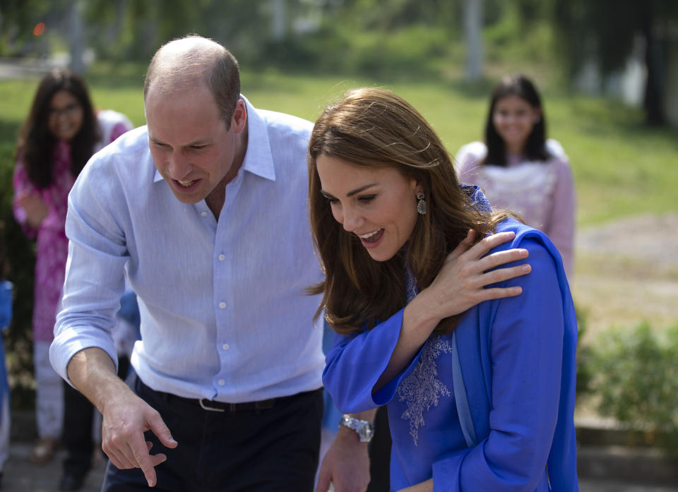 Britain's Prince William and his wife Kate speak to students during their visit to a school in Islamabad, Pakistan on Tuesday, Oct. 15, 2019. The Duke and Duchess of Cambridge, who are strong advocates of girls' education were greeted by teachers and children. (AP Photo/B.K. Bangash)