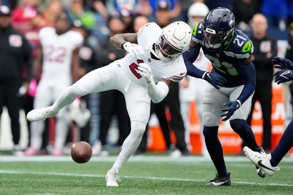 Seattle Seahawks cornerback Devon Witherspoon (21) breaks up a pass intended for Arizona Cardinals wide receiver Marquise Brown, left, during the first half of an NFL football game on Oct. 22, 2023, in Seattle.