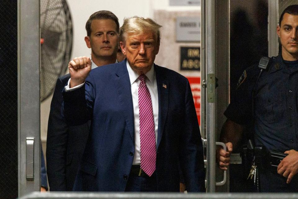 Former President Donald Trump gestures as he returns to the courtroom following a break in his trial on Friday 19 April (AP)