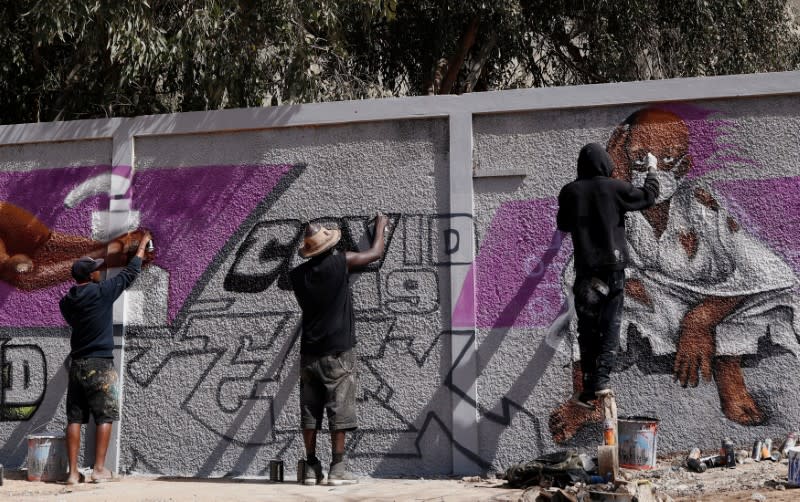 Graffiti artists from RBS crew work on their mural to encourage people to protect themselves amid the outbreak of the coronavirus disease (COVID-19), in Dakar