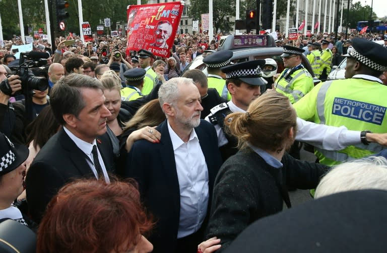 Labour leader Jeremy Corbyn (centre) leaves after delivering a speech outside the Houses of Parliament in London, on June 27, 2016