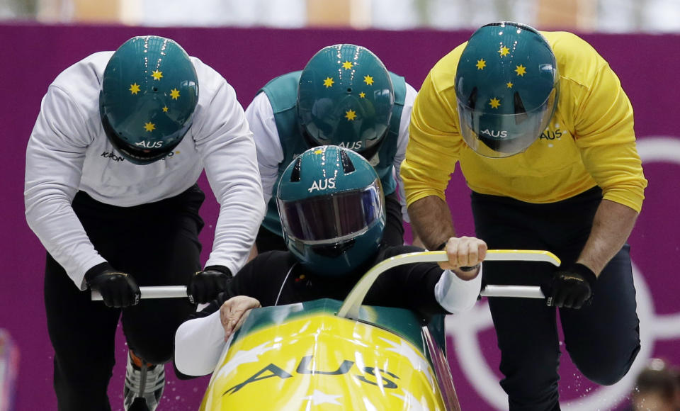 The team from Australia AUS-1, piloted by Heath Spence, start a run during the men's four-man bobsled training at the 2014 Winter Olympics, Wednesday, Feb. 19, 2014, in Krasnaya Polyana, Russia. (AP Photo/Michael Sohn)