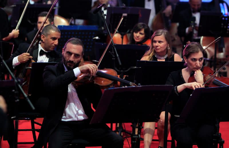 Musicians from Lebanon's philharmonic orchestra are seen on stage before the start of "Sound of Resilience" concert of the Baalbeck music festival