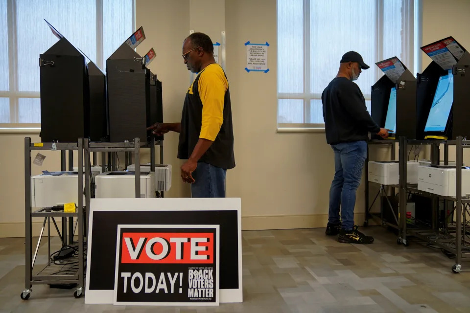 Oz Roberts, 64, casts his ballot at the start of early voting in the runoff U.S. Senate election between Democratic Senator Raphael Warnock and his Republican challenger Herschel Walker, at the City Services Center in Columbus, Muscogee County, Georgia, U.S. November 26, 2022.  REUTERS/Cheney Orr