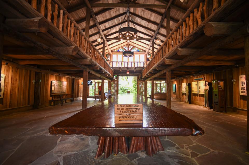 Guests of McKee Botanical Garden's walk near a historic, 35-foot long mahogany table located inside the Hall of Giants in Vero Beach, Tuesday, July 26, 2022. Peter O'Malley, former president of the Los Angeles Dodgers, has officially donated the world's largest one-piece mahogany table to the gardens after it was loaned in 2003.