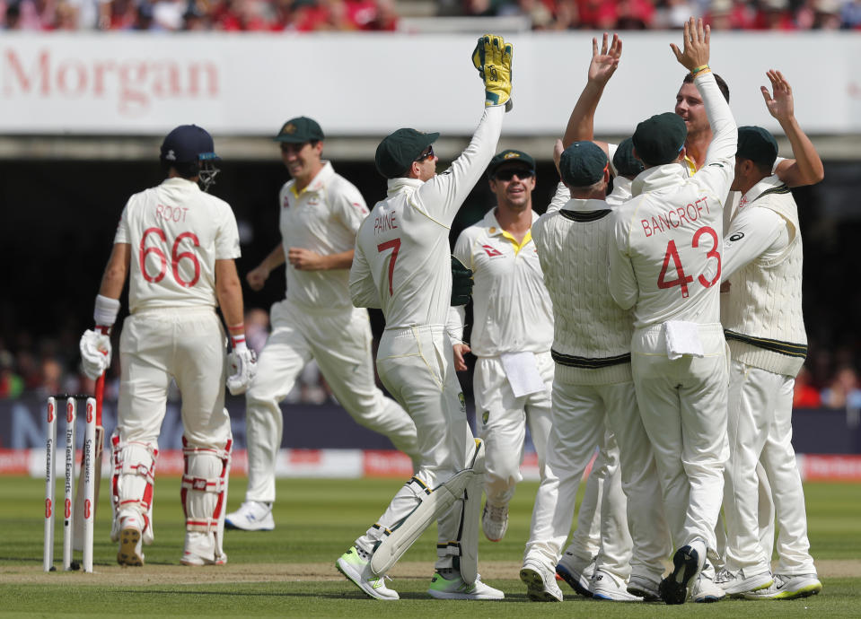 Australias players celebrates taking the wicket of England's captain Joe Root during the second day of the second Ashes test match between England and Australia at Lord's cricket ground in London, Thursday, Aug. 15, 2019. (AP Photo/Frank Augstein)