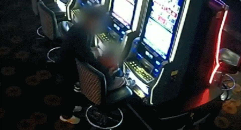 CCTV shows the man lift a small child onto a stool in front of a pokie machine.